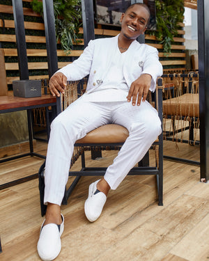 Actor Timini in an all white kochHouse suit